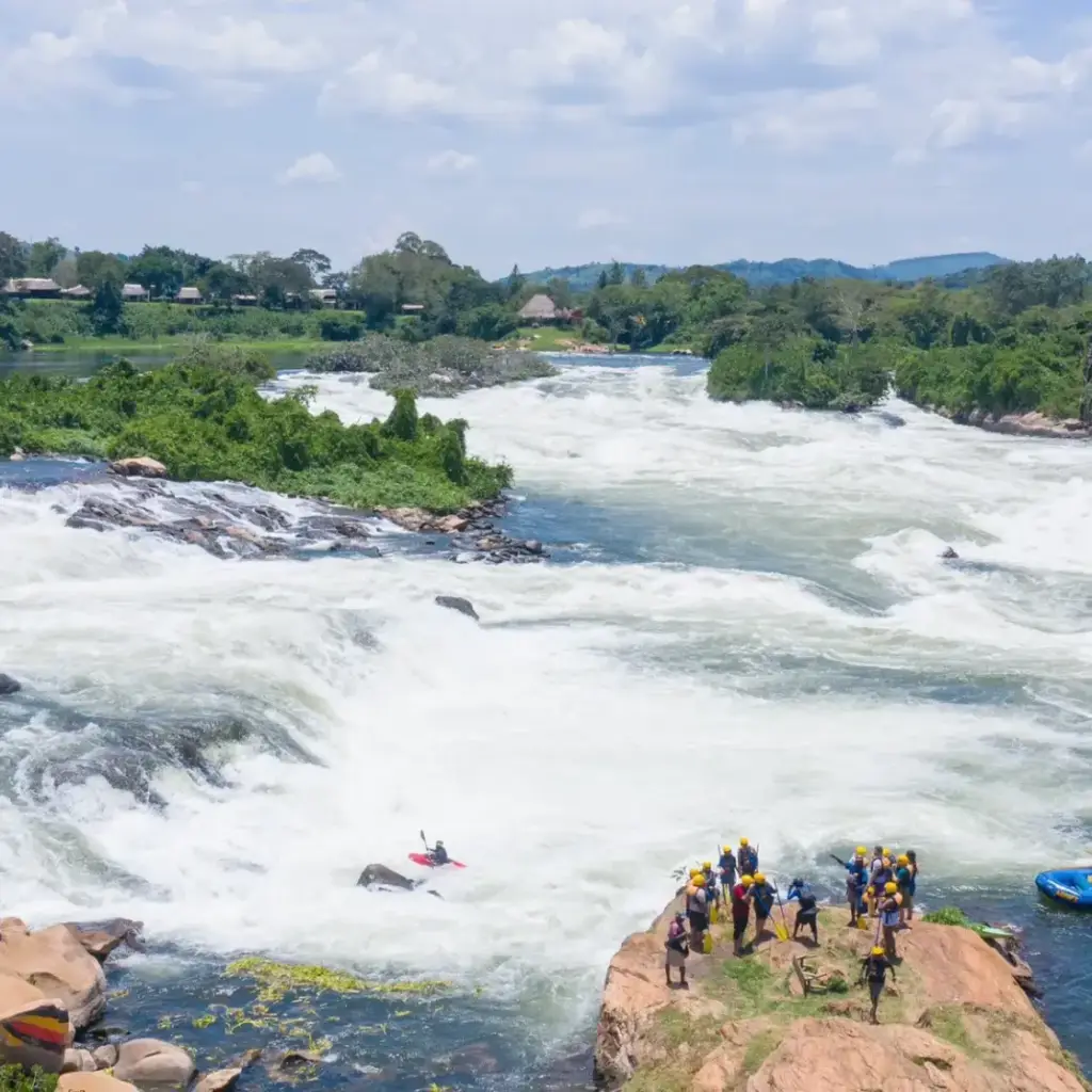 Rafters and a raft beside the white water of the Nile at Jinja