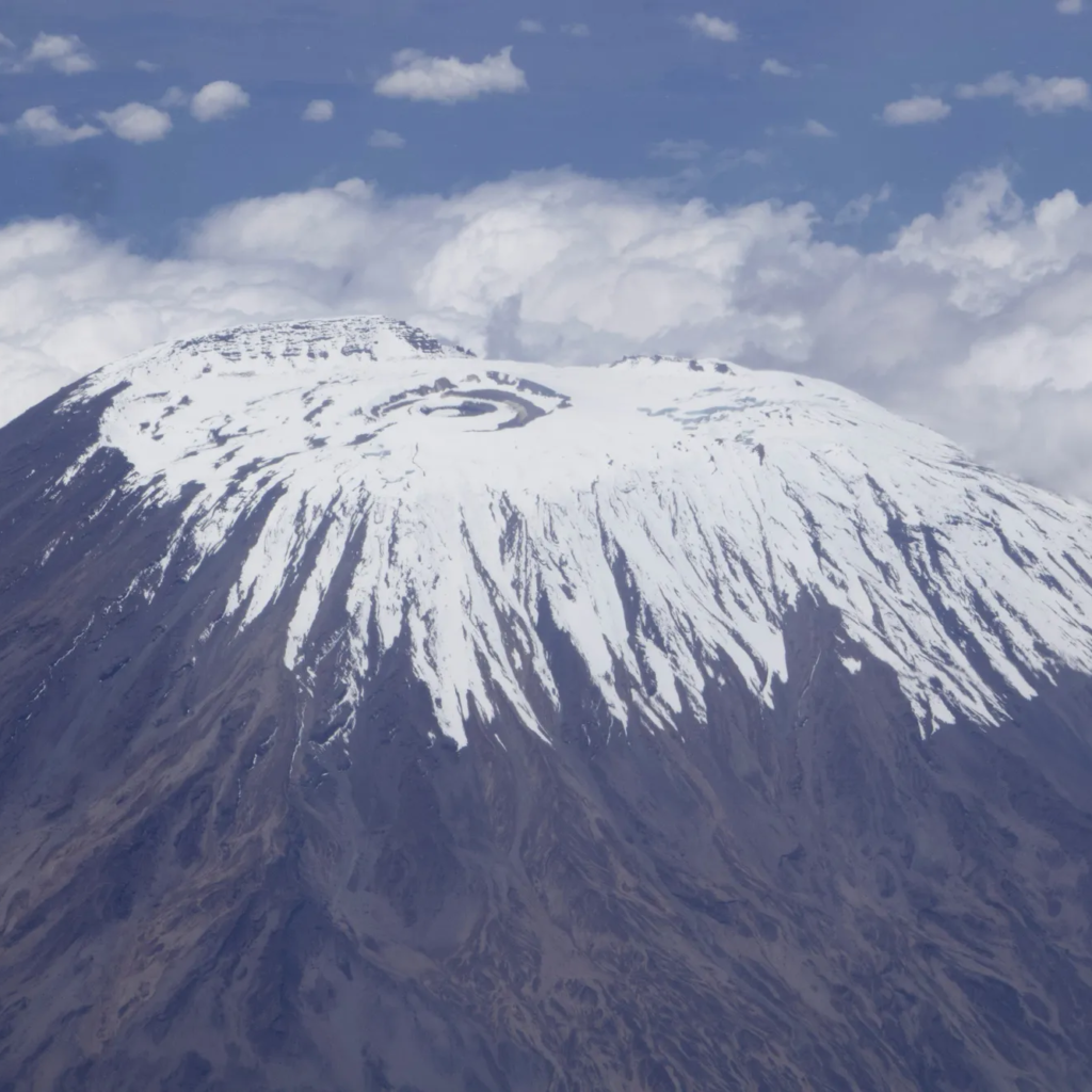 Aerial view of snow-capped Mount Kilimanjaro above the clouds