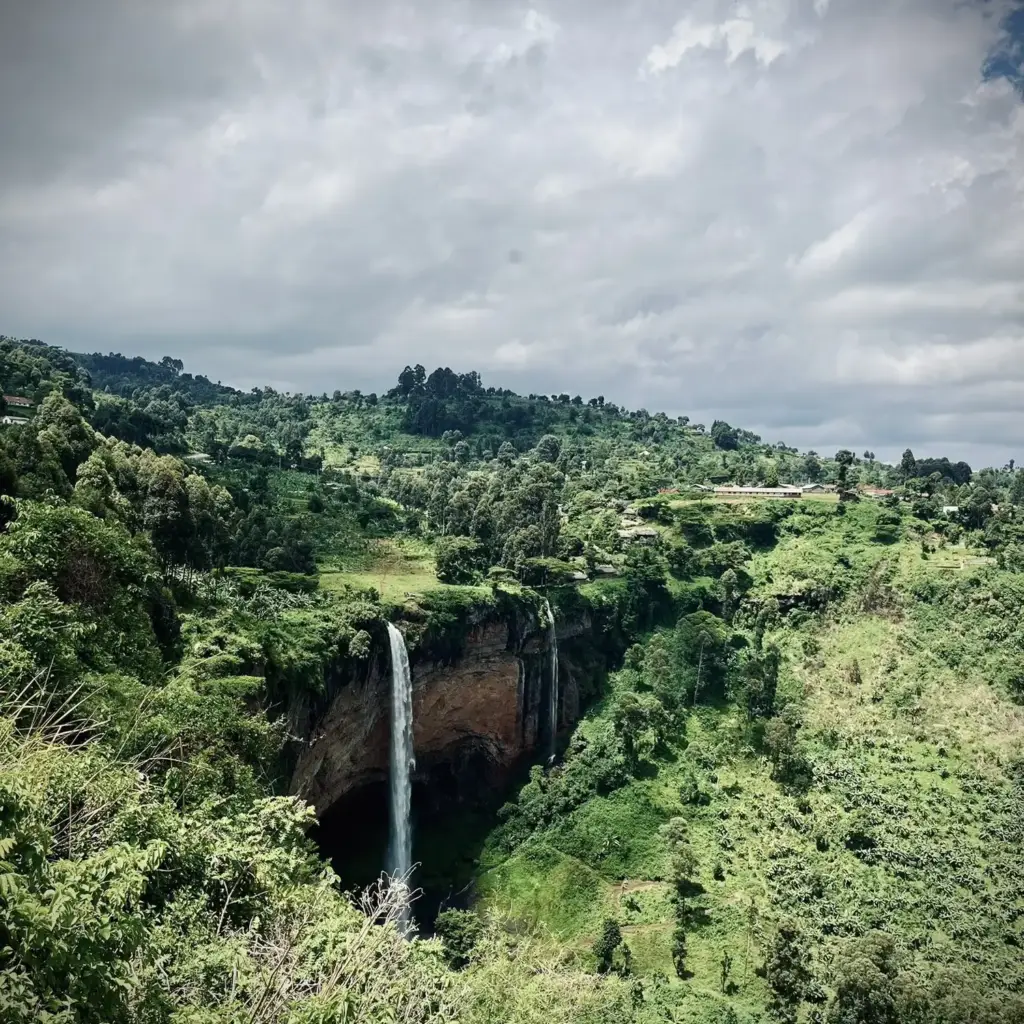 Sipi Falls cascading through green hills on Mount Elgon