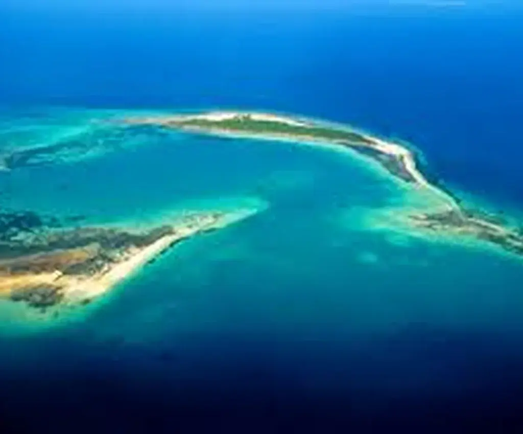Aerial view of a white sandbank in turquoise water off Zanzibar